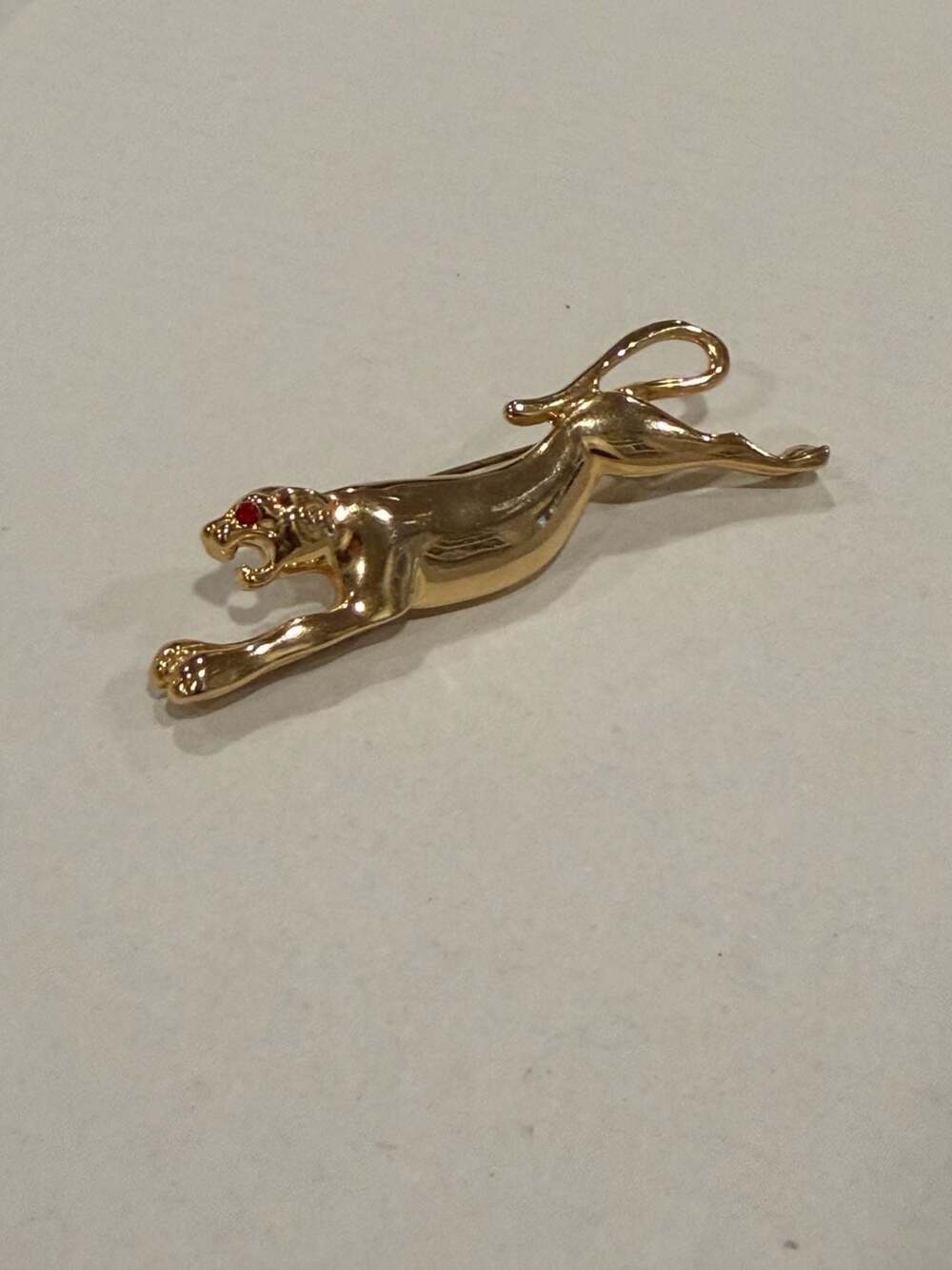 Vintage Gold Tone Leaping Panther Brooch with Red Rhinestone Eyes